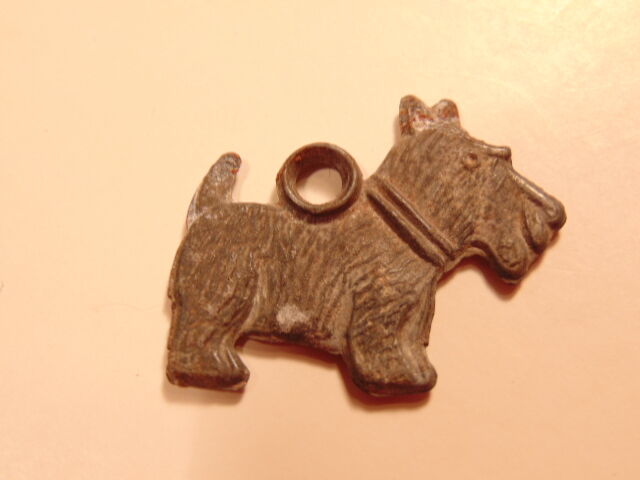 Vintage metal pendant of terrier type dog