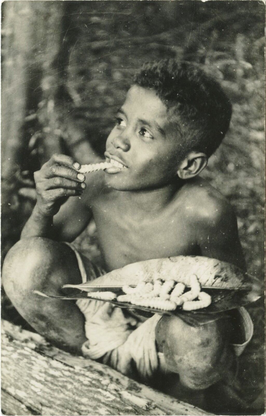 CHARMING AFRICAN BOY ENJOYS EATING WITH BANANA LEAVES & VINTAGE PHOTO POSTCARD
