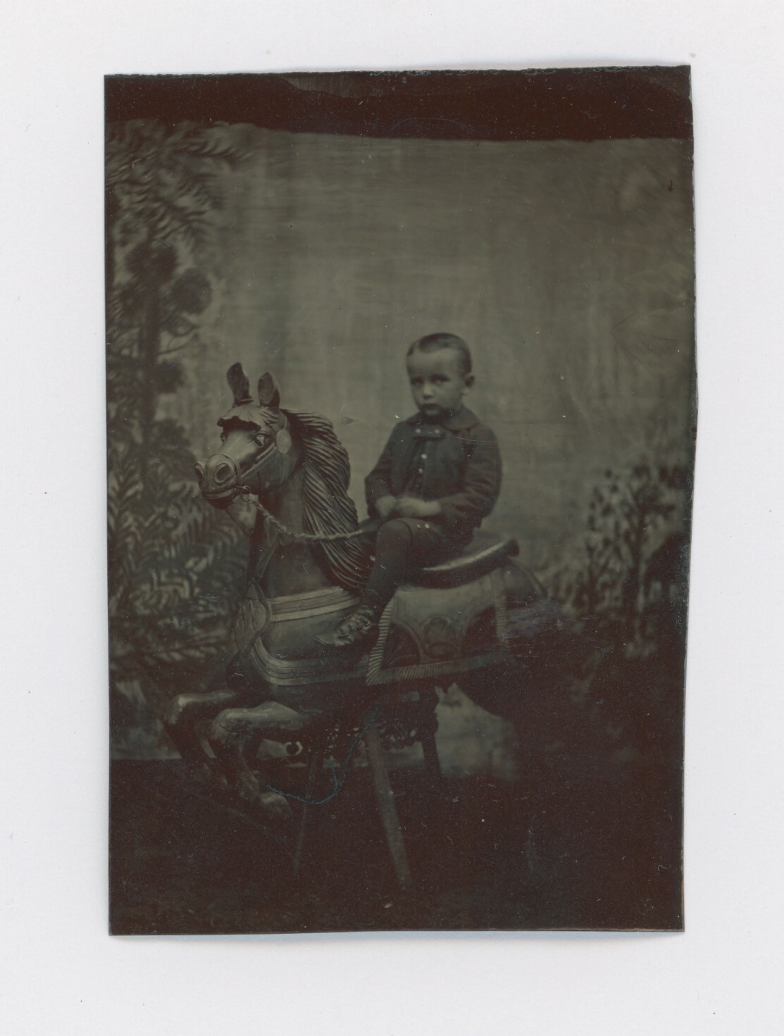 CIRCA 1870's-1880's TINTYPE OF A BOY RIDING ON A CAROUSEL HORSE, VERY RARE