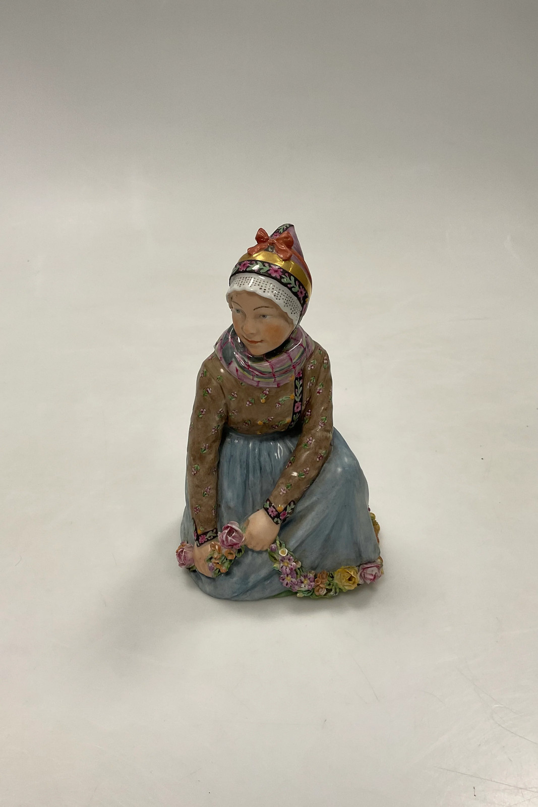 Royal Copenhagen Seated Fano Girl Figurineby Carl Martin-Hansen No. 12413 Royal Copenhagen Seated Fano Girl Figurineby Carl Martin-Hansen No. 12413